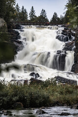 Fototapeta premium Photo of a waterfall photograph using slow shutter speed and long exposure located in Quebec, Canada. Parc Régional des Chutes Monte à Peine et des Dalles