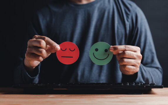 Man Hands holding sad face hiding or behind happy smiley face, bipolar and depression, mental health concept, personality, mood change, therapy healing split concept...