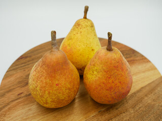 Three spotted pears on a wooden table