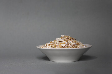 white plate oatmeal isolated on gray background