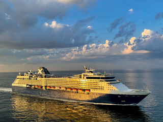 Luxury cruise liner sailing during sunset