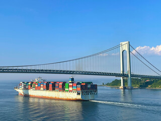 Ultra large container ship passing under Verrazzano-Narrows Bridge during departure from New York...