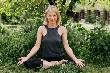 Portrait of a woman forty years old smiling positive meditation and yoga