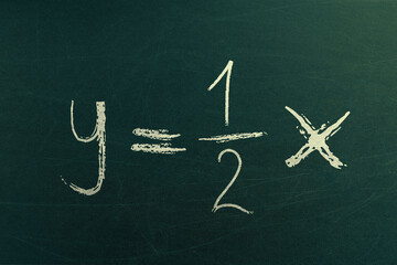 Sketch of math equation on blackboard. Fractions learning and examples. Handwritten on chalkboard