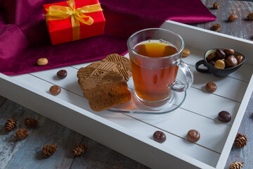 A cup of tea and spiced bisquit on a tray