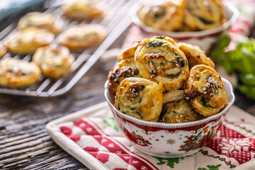 Christmas savory pastries, mini pizza cakes in a typical Christmas dish and festive decorations