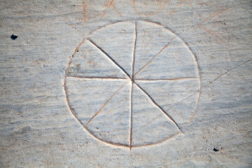 An ancient Roman game-stone carved in the floor