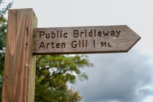 Wooden signpost for a public bridleway to the Arten Gill viaduct near Sedbergh in the Yorkshire Dales in England, UK.