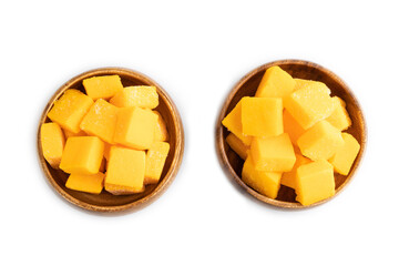 Dried mango cubes in wooden bowls isolated on white, top view