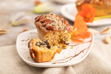 Caramel and almond cake on brown concrete, side view, selective focus