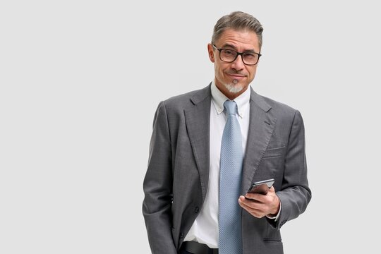 Business Portrait Of Confident Businessman With Phone. Entrepreneur In Jacket And Tie, Smiling, Happy Mid Adult, Mature Age Man Standing, Smiling, Isolated On White Background.