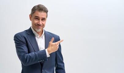 Business portrait of confident businessman. Salesman showing pointing at blank space. Entrepreneur in jacket smiling, Happy mid adult, mature age man standing, smiling, isolated on white background.