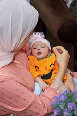 emotional shot of a mother and her newborn cute baby after the birth, 