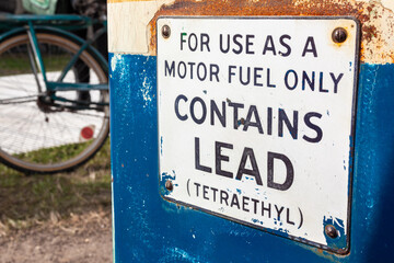 Old Petrol, Gas or Gasoline Fuel Pump With Lead Warning Sign - obrazy, fototapety, plakaty