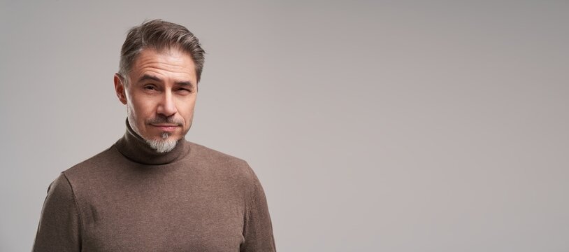 Portrait Of Handsome Serious Man Standing On White Background.