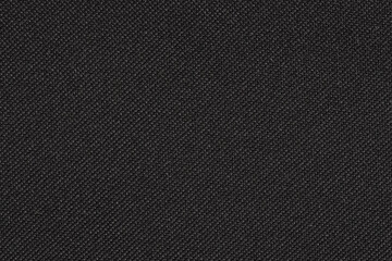 Black synthetic fibre fabric texture, closeup view from above