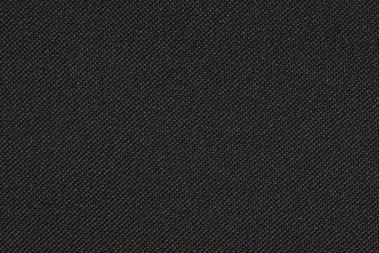 Black synthetic fibre fabric texture, closeup view from above