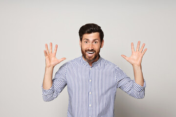 Fototapeta premium Portrait of emotional bearded man on grey background