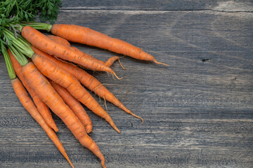 Organic carrots on a wooden table.