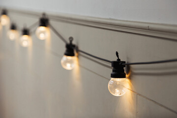 Vintage garland. Incandescent light bulbs in the cafe at the bar. Retro lighting in interior