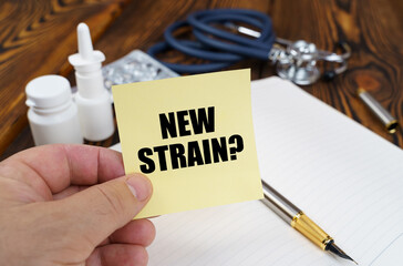 The doctor is holding a sticker with the inscription - new strain