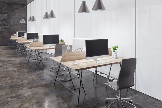 Perspective view on minimalistic style workspaces with modern computers on light wooden tables, black office chairs on dark marble floor near light matte walls. 3D rendering