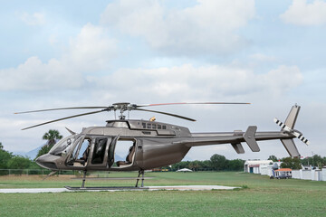 Fototapeta na wymiar Beautiful modern helicopter on helipad in field