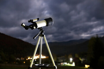 Modern new telescope and mountains in evening