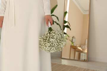 Bride with beautiful bouquet indoors, closeup view. Wedding day