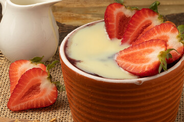 Portion of Brazilian açaí with strawberry and condensed milk.