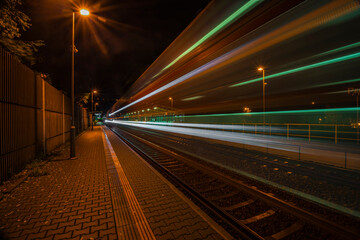 Fototapeta na wymiar Railway track and train light in night in Prague Podbaba station