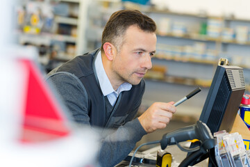 man using computer in hardware store