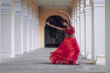 Yogini dancing and practicing yoga near a palace in Mysore, India. Mindful yoga practice....
