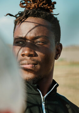 portrait of a man under soccer goal 