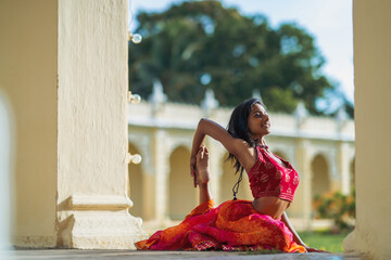 Yogini dancing and practicing yoga near a palace in Mysore, India. Mindful yoga practice....
