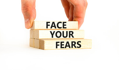 Face your fears and support symbol. Concept words Face your fears on wooden blocks. Businessman...