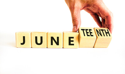 Juneteenth in June symbol. Concept words Juneteenth and June on wooden cubes. Beautiful white table...