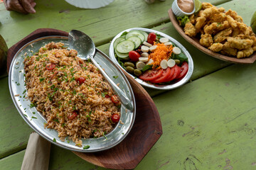 Seafood, fish strips and salad served on the beach table