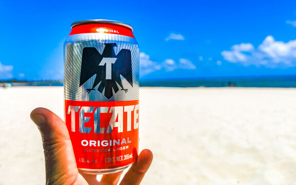 Drinking can of cold beer on beach in paradise Mexico.