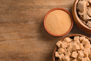 Different types of sugar on wooden table, flat lay. Space for text