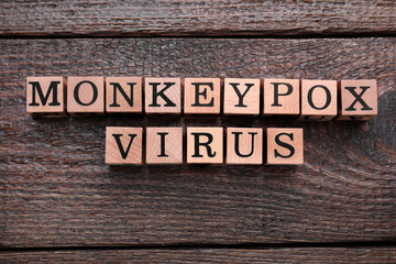 Words Monkeypox Virus made of cubes on wooden table, flat lay