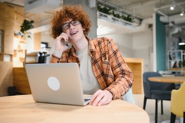 male programmer wear spectacles for eyes protection while working on freelance via laptop computer,clever student watching tutorial on netbook.