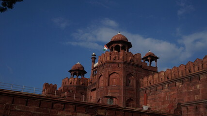 Fototapeta na wymiar Red Fort with moody skies at sunset Delhi UNESCO World Heritage Site Red Fort in India A heritage site made of red sandstone during the Mughal rule