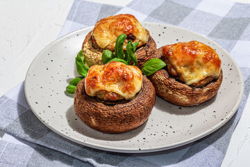 Baked stuffed mushroom caps ready for eating. Champignons, spices, vegetables, cheese