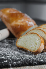 Slices of whole grain rye fresh bread on a dark background close up. Fresh home-baked sourdough bread