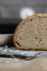 Slice of homemade bread, natural agricultural products. Healthy and tasty pastries. Whole grain bread, eggs, flour. Close up, dark background