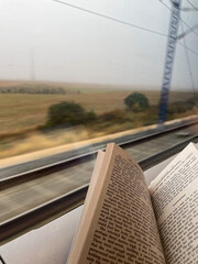Opened book on high speed train on a foggy day