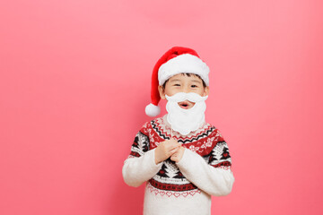 Merry Christmas! Young girl celebrating Christmas against pink background