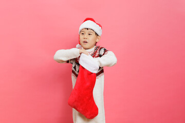 Merry Christmas! Young girl celebrating Christmas against pink background