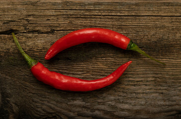 Hot peppers on a wooden background.
